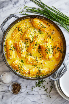 Corn on the Cob boiled in a milk-butter bath and seasoned with chives.